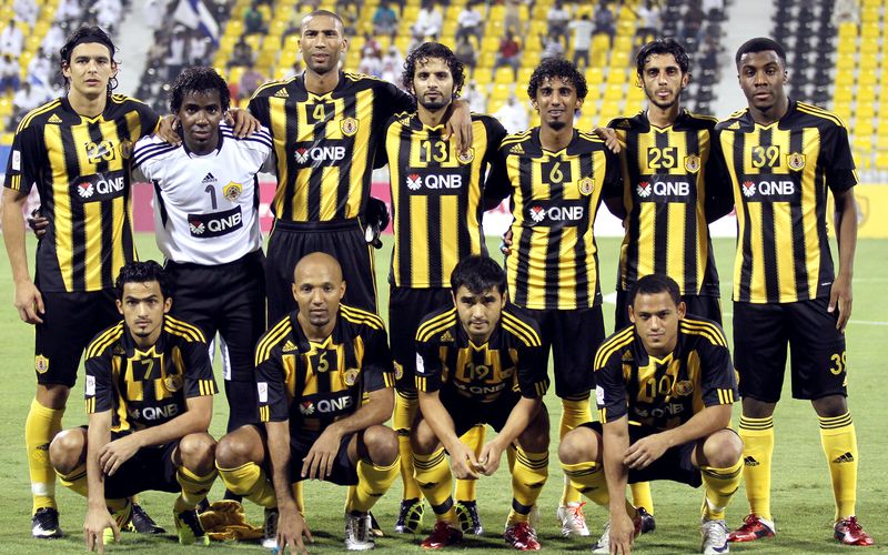 A Qatar SC side lines up before a league match